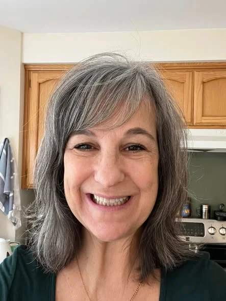 Emily P. smiling with her grandson