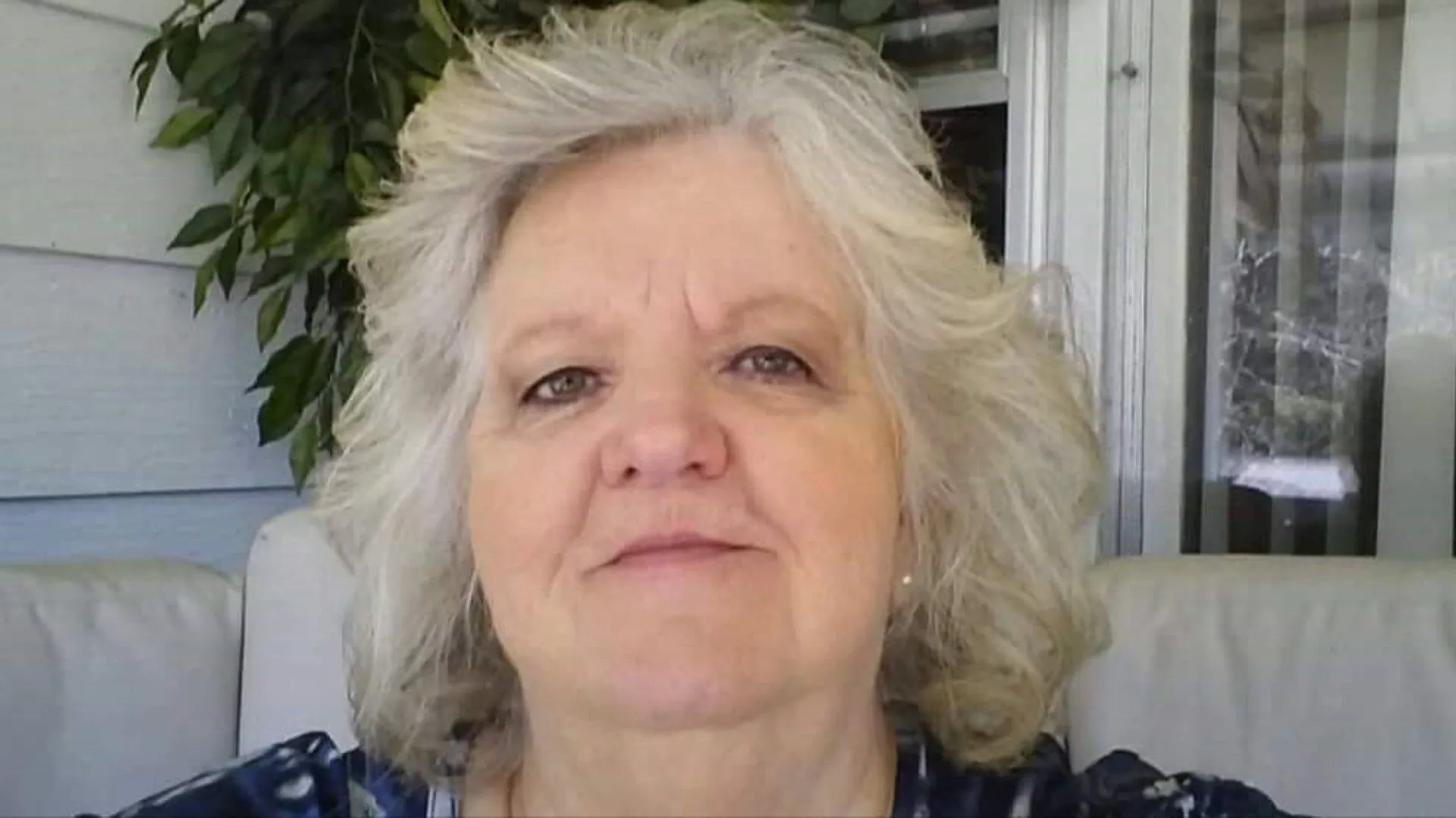 Linda S. organizing her planner at home